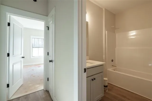 a bathroom with a shower and a sink