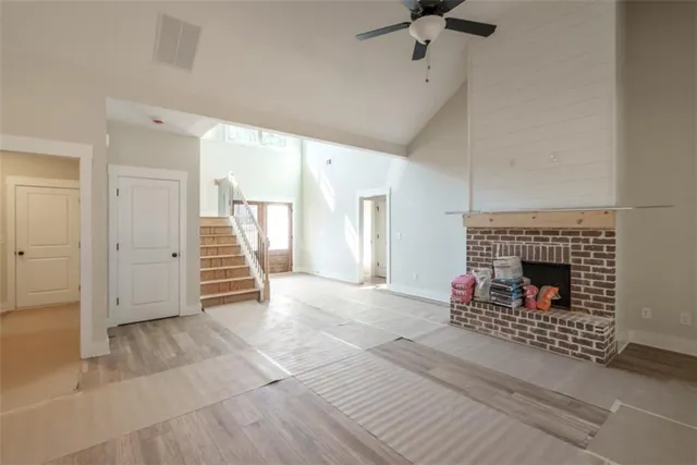 a view of a livingroom with a fireplace and window