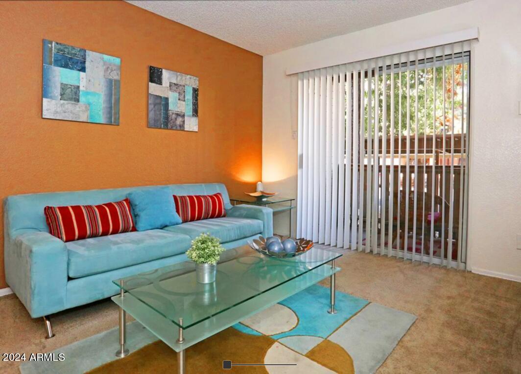 8902 North 19th Avenue, Unit A2 Phoenix, AZ 85021 - Photo 2 of 10 a living room with furniture and a window