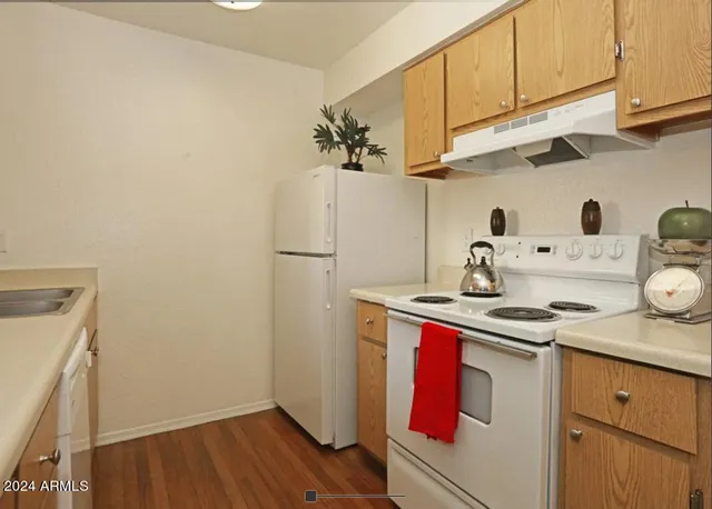 a kitchen with stainless steel appliances a sink a stove and refrigerator