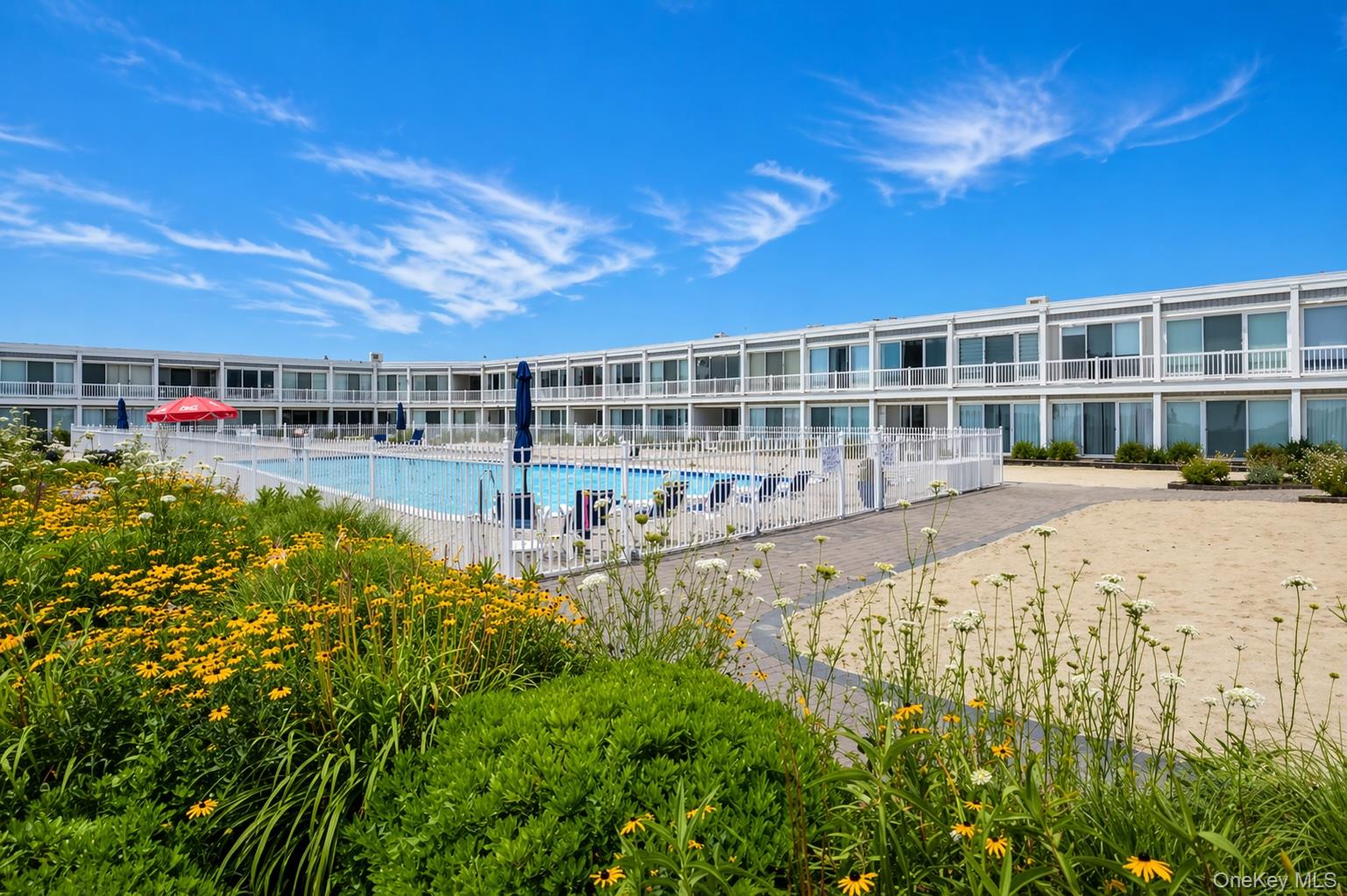 585 Dune Road, Unit B1012 Westhampton, NY 11978 - Photo 11 of 11 a view of swimming pool with outdoor space and seating area