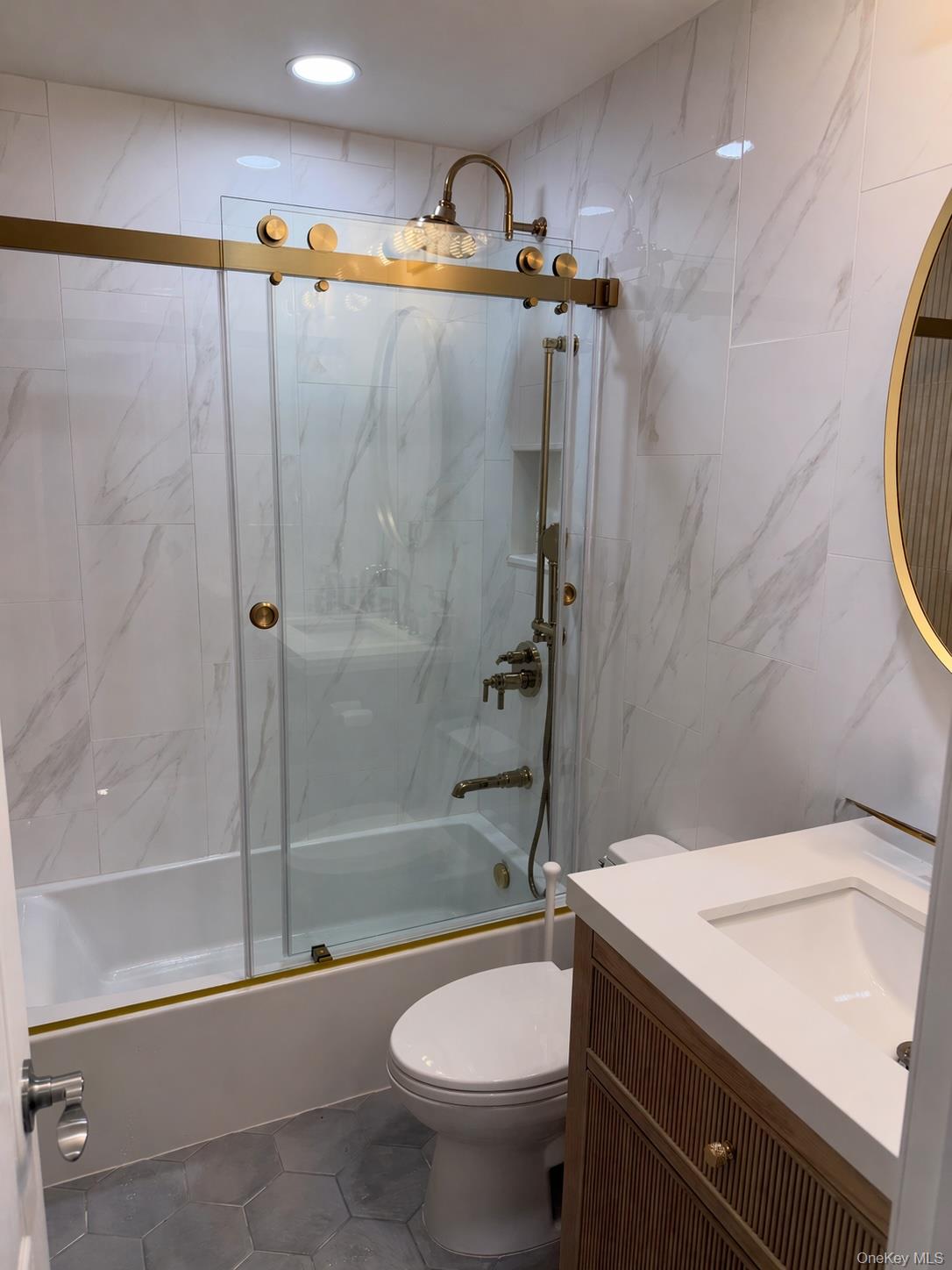 585 Dune Road, Unit B1012 Westhampton, NY 11978 - Photo 5 of 11 a bathroom with a granite countertop sink a toilet and shower