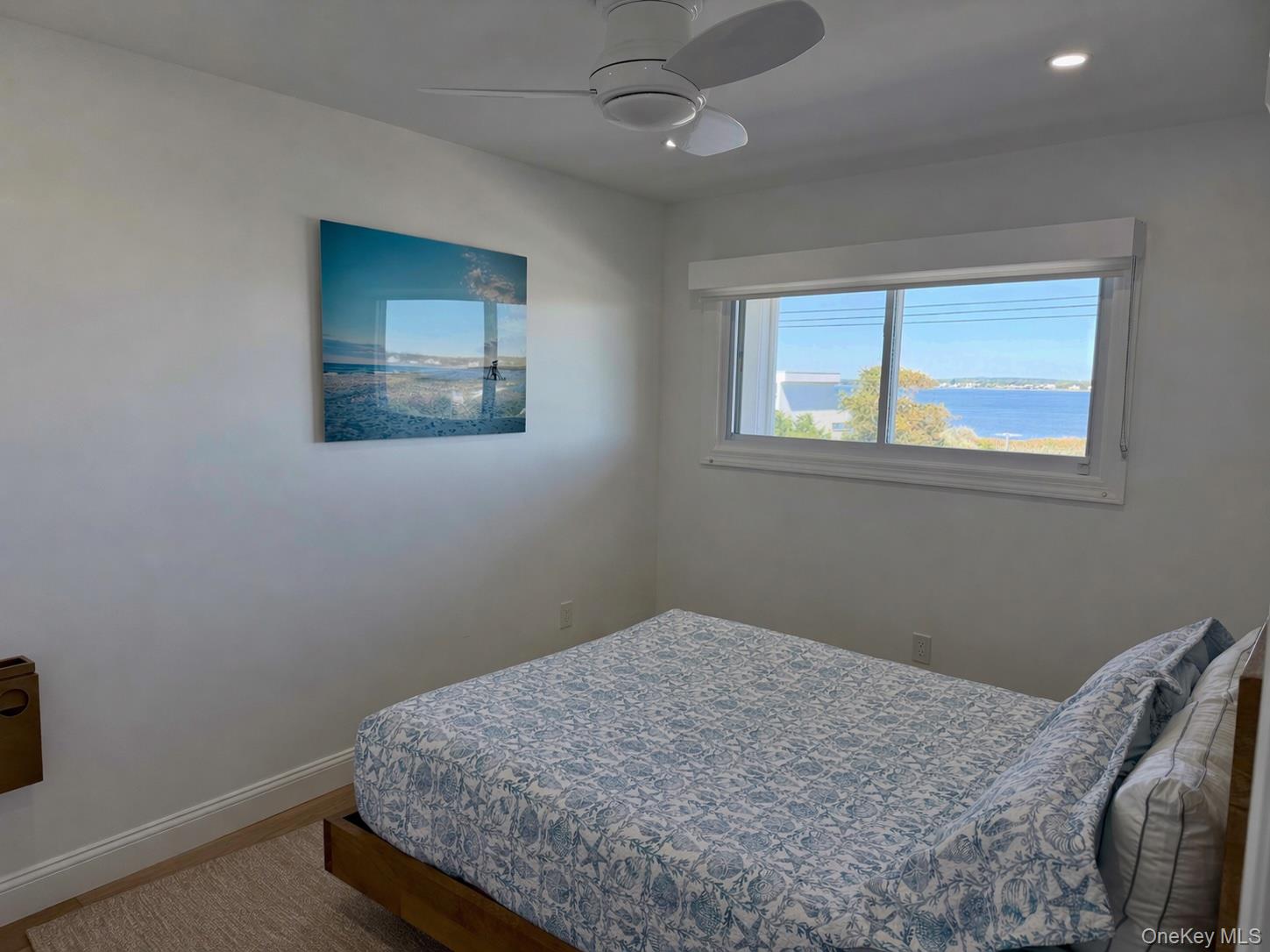 585 Dune Road, Unit B1012 Westhampton, NY 11978 - Photo 6 of 11 a bedroom with a bed and a window