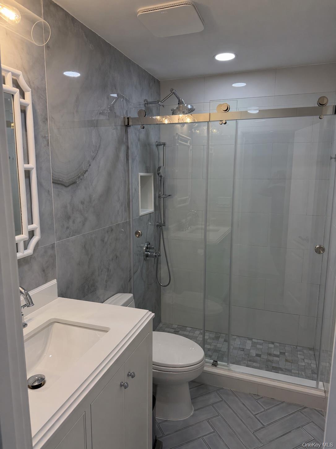 585 Dune Road, Unit B1012 Westhampton, NY 11978 - Photo 7 of 11 a bathroom with a sink toilet and shower
