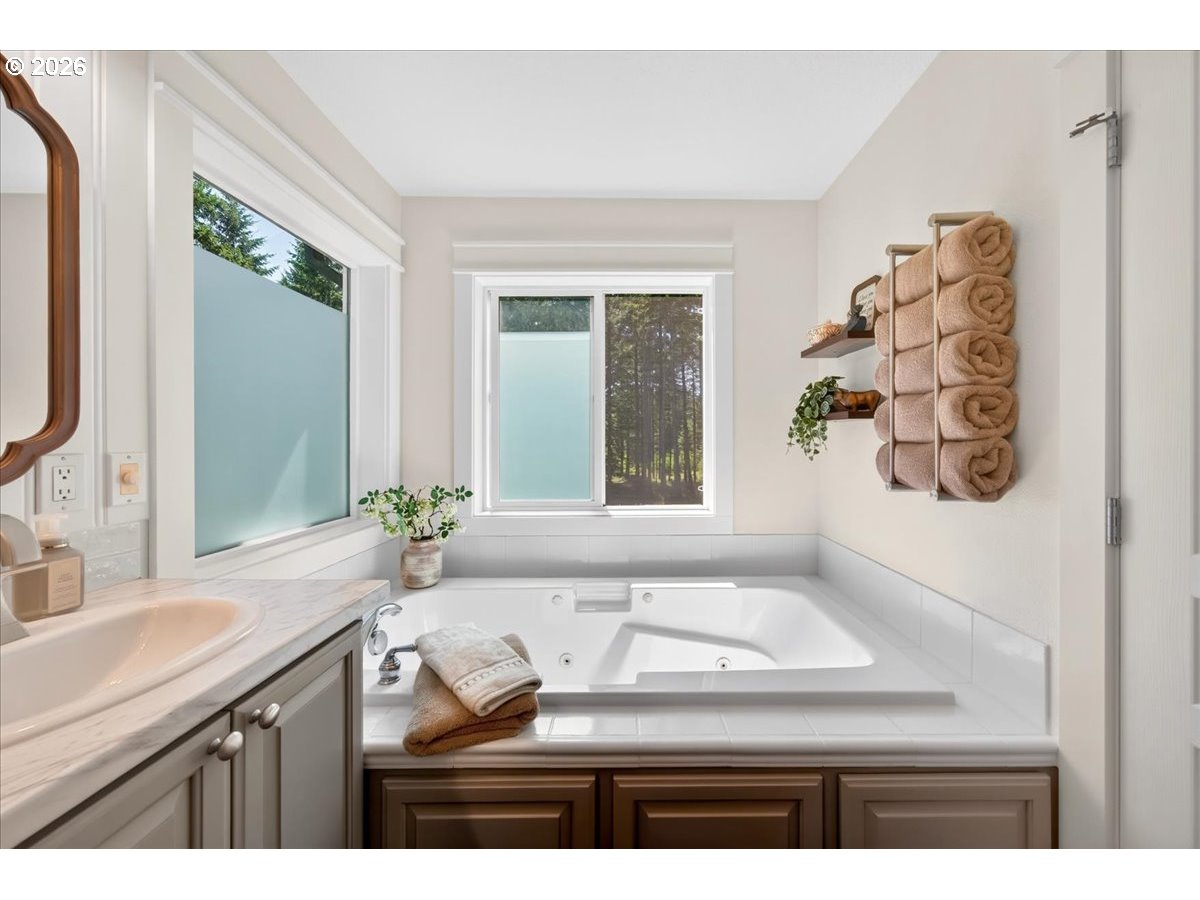 28311 Northwest Nowakowski Road Buxton, OR 97109 - Photo 28 of 48 a bathroom with a granite countertop sink a large mirror and a window