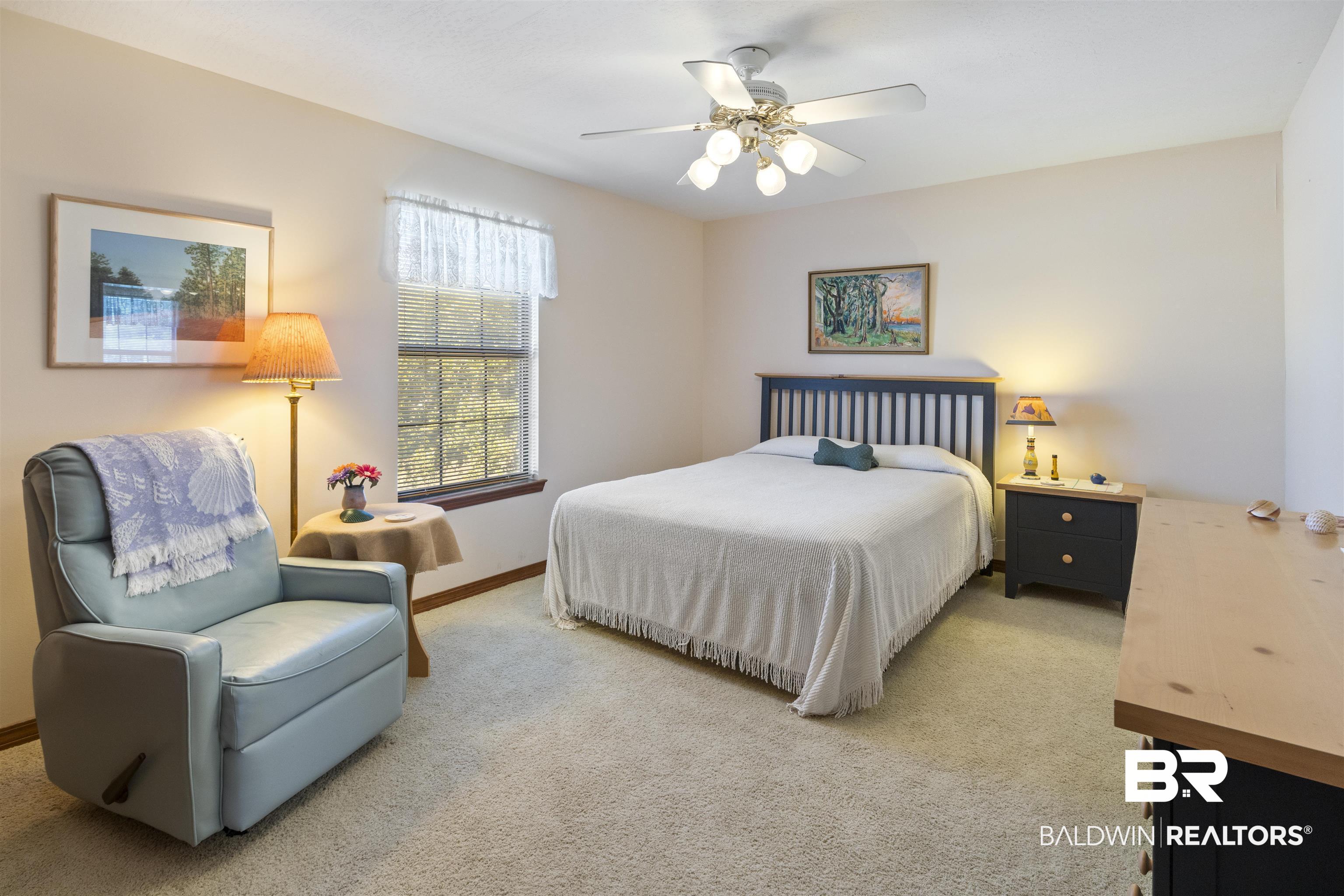 27321 Marina Road Orange Beach, AL 36561 - Photo 34 of 55 Bedroom with light carpet and ceiling fan