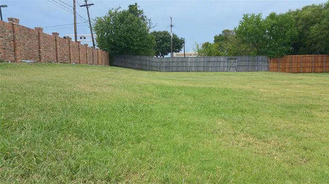 a view of a backyard with wooden fence