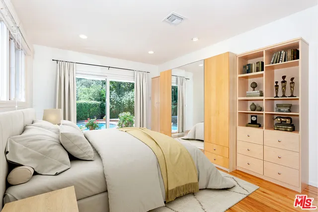 a bedroom with bed and a large window