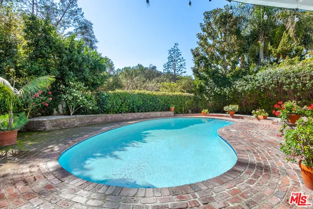 a view of a swimming pool with a yard