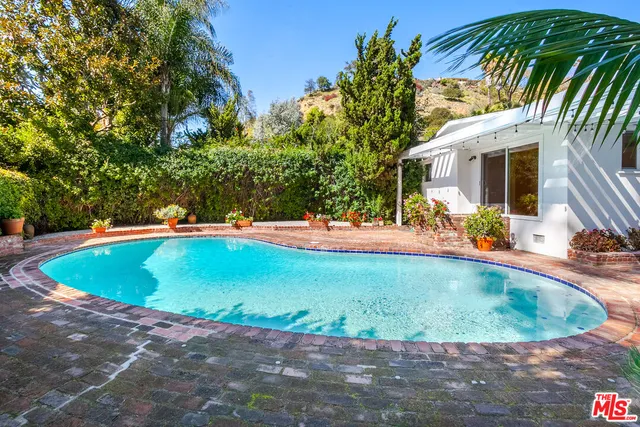 a view of a swimming pool with a patio