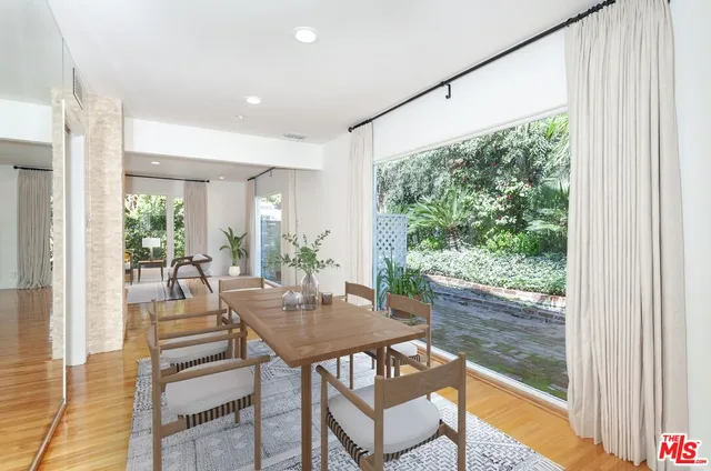 a dining room with wooden floor wooden floor and a table
