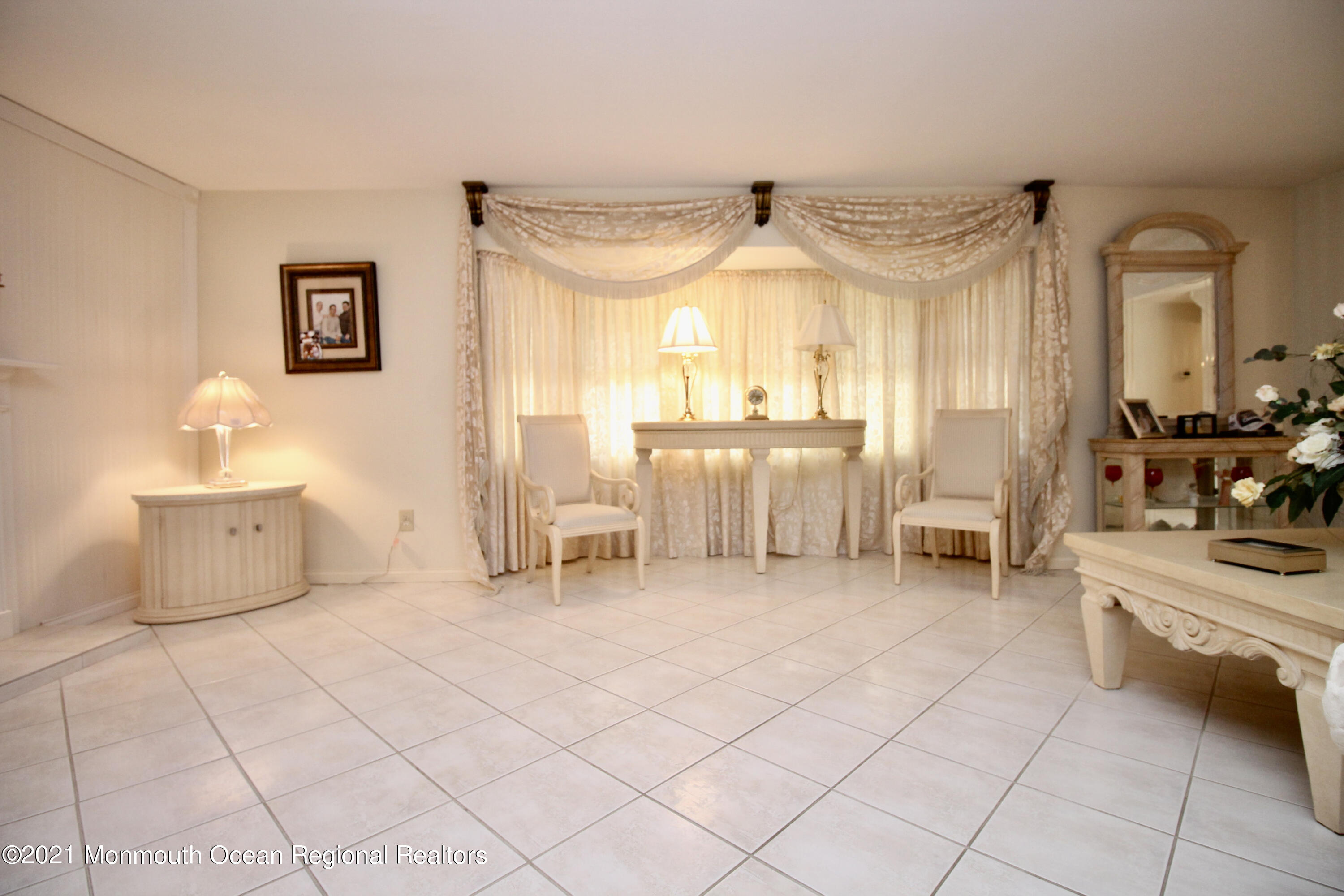 61 Crosswicks Road Freehold, NJ 07728 - Photo 14 of 43 a living room with furniture and a chandelier