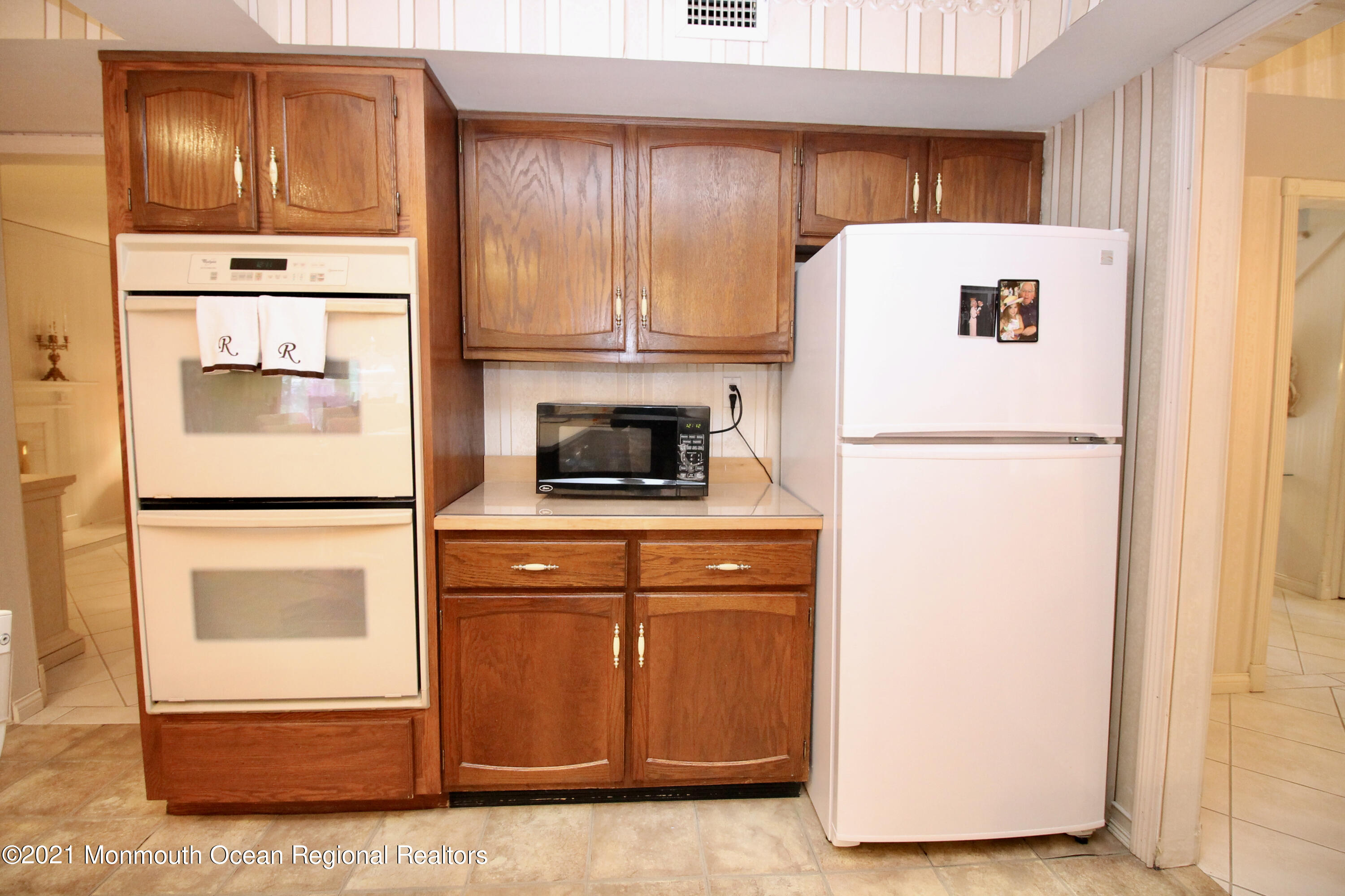 61 Crosswicks Road Freehold, NJ 07728 - Photo 22 of 43 a white refrigerator freezer and a stove sitting inside of a kitchen