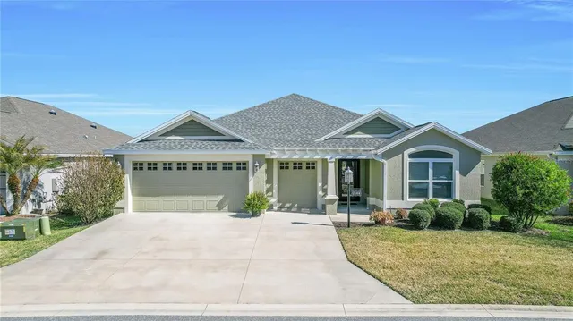 a view of house with yard and potted plants