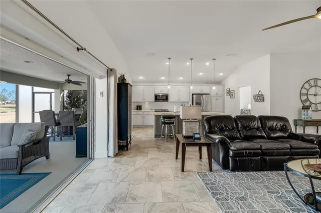 a kitchen with a sink a stove and chairs