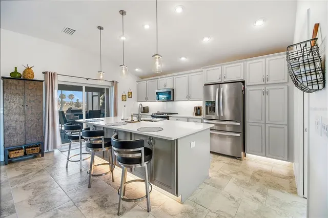 a kitchen with stainless steel appliances a sink stove top oven and cabinets
