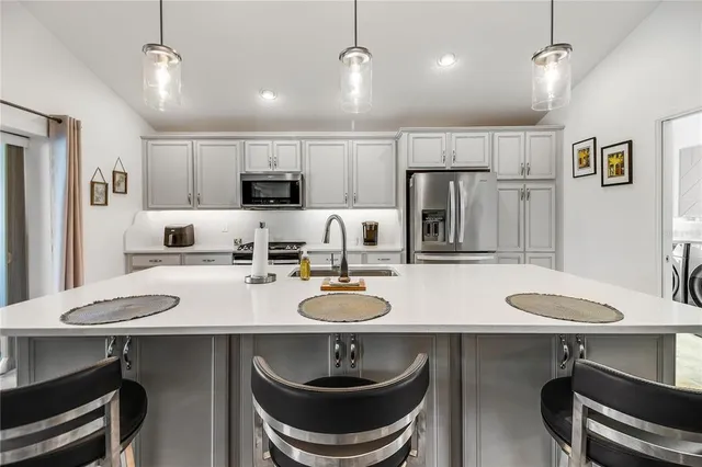 a utility room with sink dryer and washer