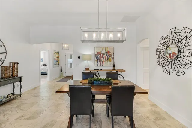 a bedroom with a bed and painting on the wall