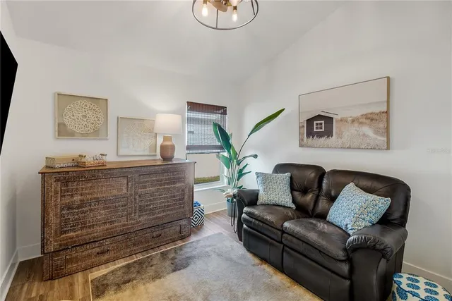 an aerial view of residential houses with outdoor space and ocean view
