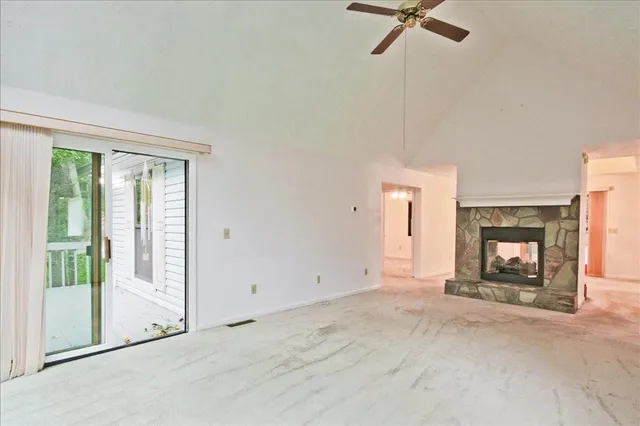 a view of empty room with a fireplace
