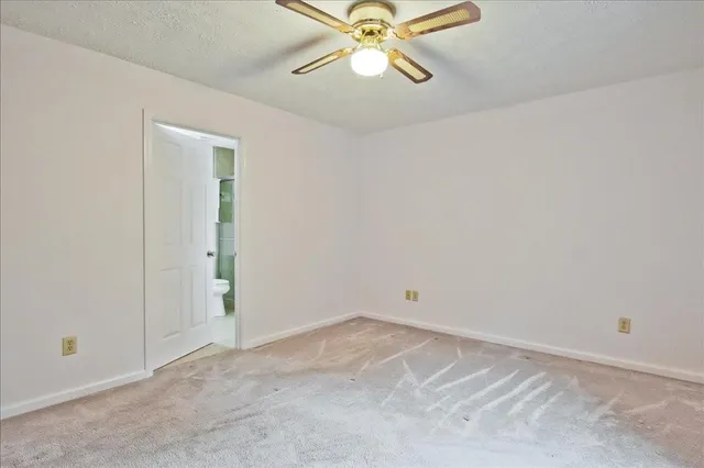 a bathroom with a granite countertop sink toilet a mirror and shower