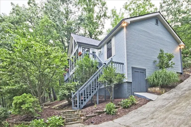 a house that has a flower plants with wooden fence