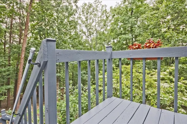 a view of balcony with wooden floor and fence