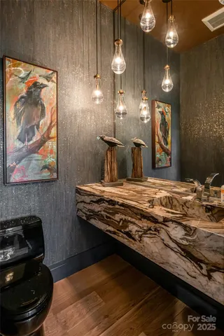 a bathroom with a sink mirror and toilet