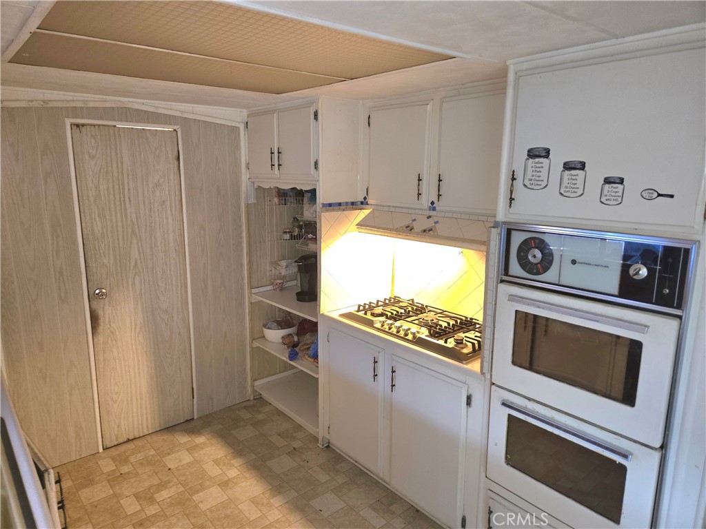 2230 Lake Park Drive, Unit 54 San Jacinto, CA 92583 - Photo 12 of 22 a kitchen with stainless steel appliances granite countertop a stove and a refrigerator