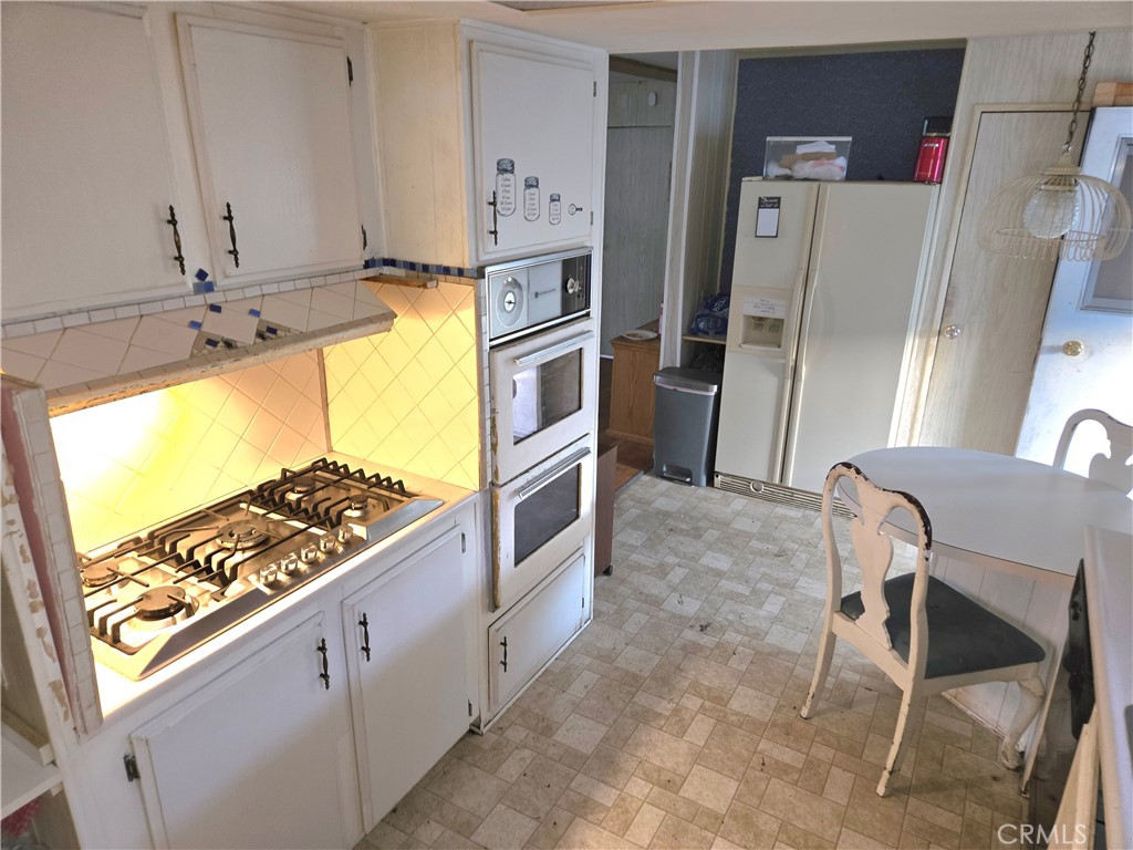 2230 Lake Park Drive, Unit 54 San Jacinto, CA 92583 - Photo 13 of 22 a view of a kitchen with furniture and a window