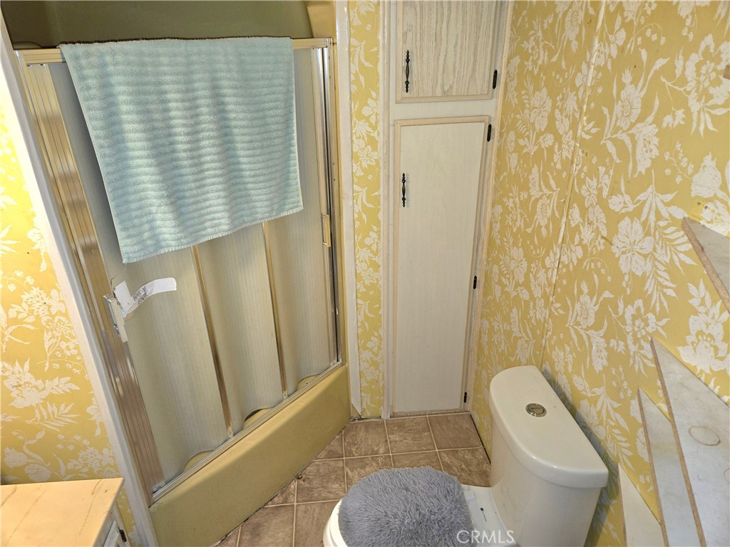 2230 Lake Park Drive, Unit 54 San Jacinto, CA 92583 - Photo 17 of 22 a bathroom with a shower curtain and a sink