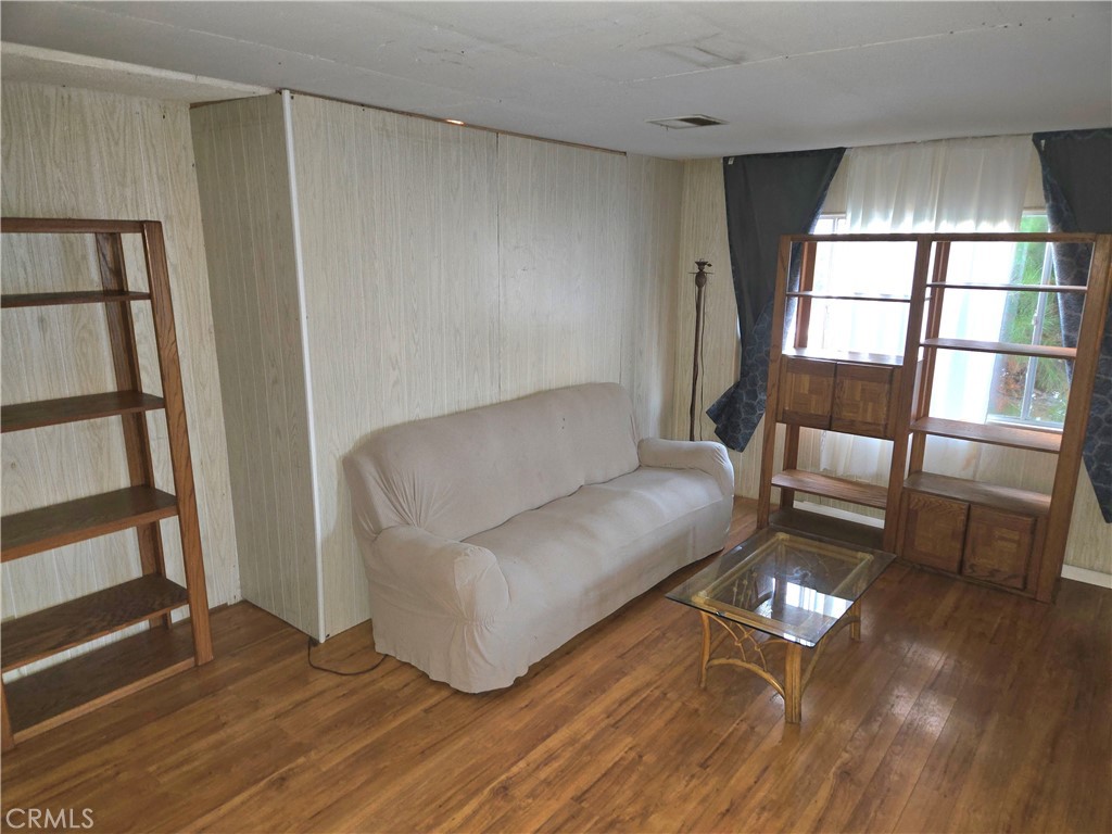 2230 Lake Park Drive, Unit 54 San Jacinto, CA 92583 - Photo 5 of 22 a living room with furniture and a hard wood floor