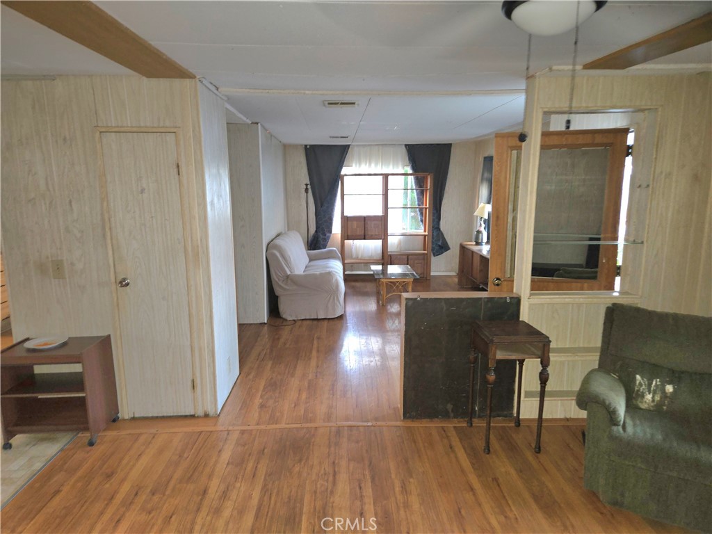 2230 Lake Park Drive, Unit 54 San Jacinto, CA 92583 - Photo 7 of 22 a living room with furniture and a wooden floor