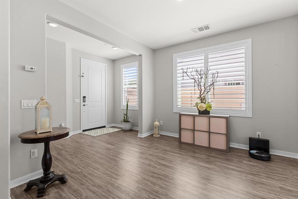29809 Gypsy Vanner Way Menifee, CA 92584 - Photo 4 of 45 a view of a room with a window and wooden floor