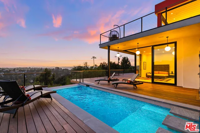 a view of a swimming pool with a table and chairs