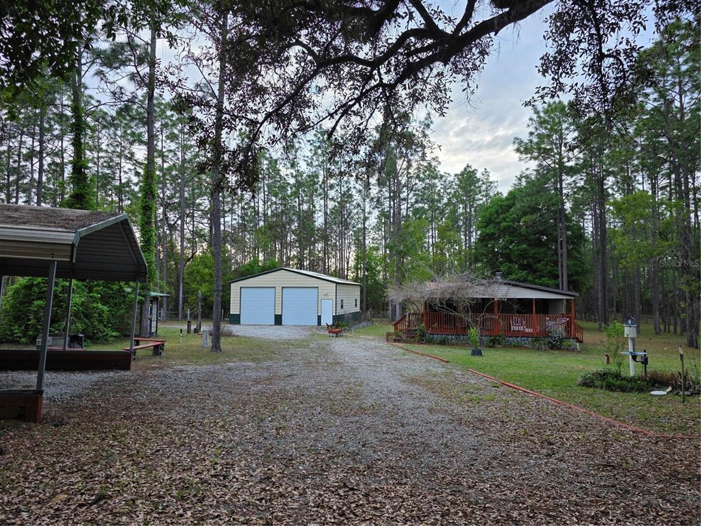 a view of a house with a yard and tree s