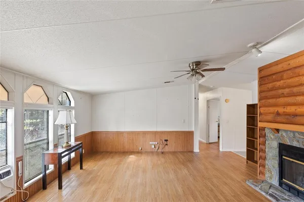 a view of a workspace with furniture and wooden floor