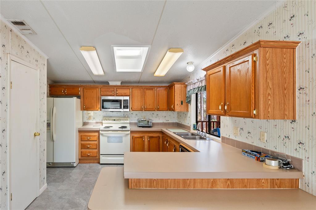 110 Hill Top Loop Hawthorne, FL 32640 - Photo 23 of 52 a kitchen with stainless steel appliances granite countertop a sink and a refrigerator