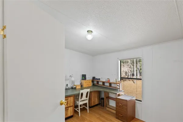 a view of backyard with wooden fence and a large tree