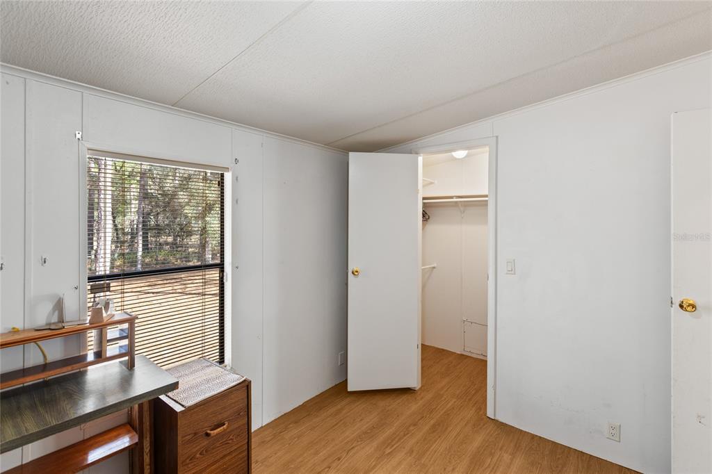 110 Hill Top Loop Hawthorne, FL 32640 - Photo 25 of 52 a view of a livingroom with wooden floor and a window