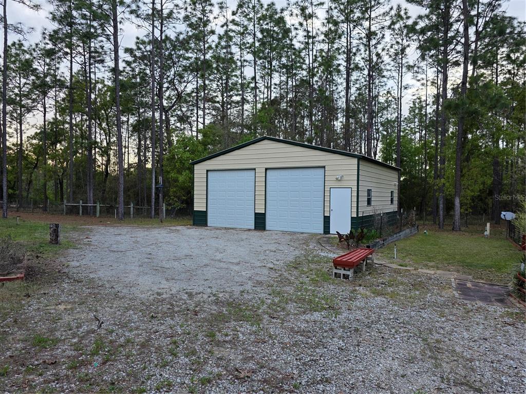 110 Hill Top Loop Hawthorne, FL 32640 - Photo 48 of 52 a view of backyard with wooden fence and a large tree