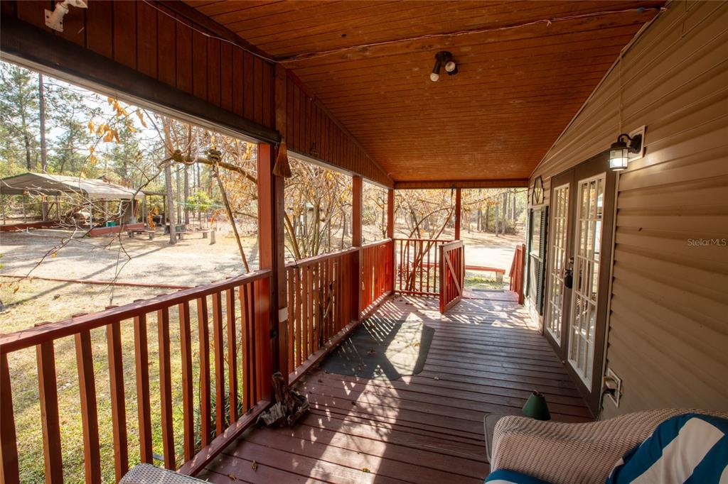 110 Hill Top Loop Hawthorne, FL 32640 - Photo 7 of 52 a view of a porch with wooden floor and furniture