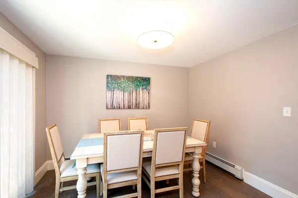 a view of a dining room with furniture and a window