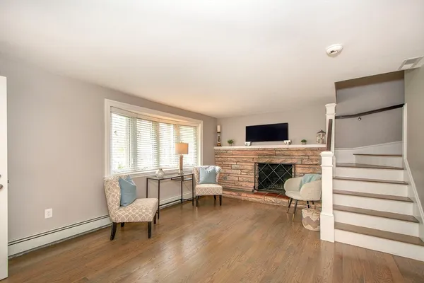 a living room with furniture wooden floor and a fireplace