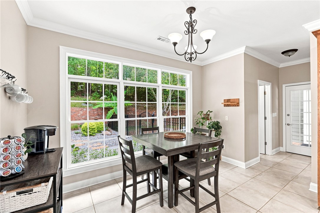 320 Watson Road Easley, SC 29642 - Photo 15 of 50 Ample natural light streams through large windows onto classic tile flooring in this inviting dining space.