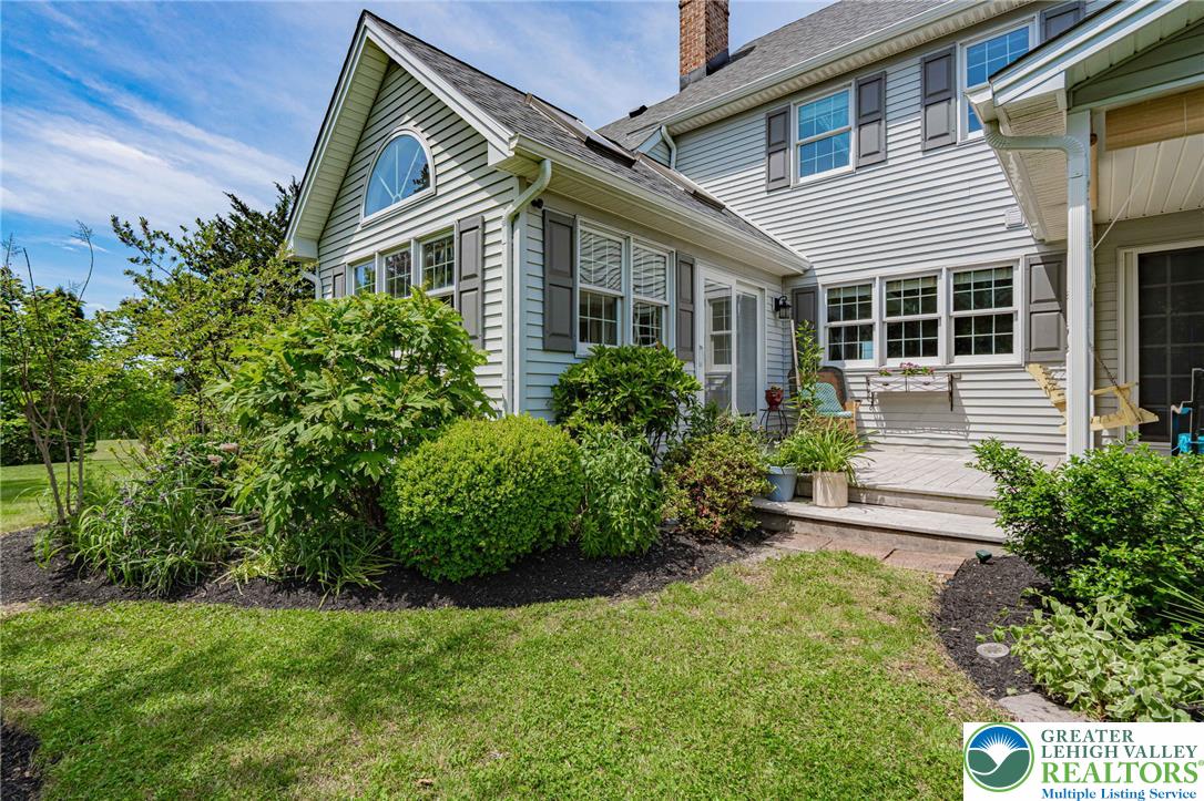 4542 Springfield Drive Coplay, PA 18037 - Photo 65 of 89 A classic facade with well-maintained landscaping and a welcoming side porch awaits.