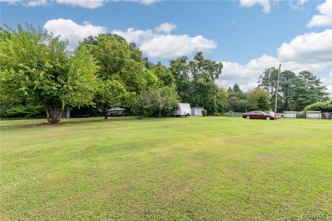 25500 Front Road Petersburg, VA 23803 - Photo 4 of 19 a view of a green field with trees in the background