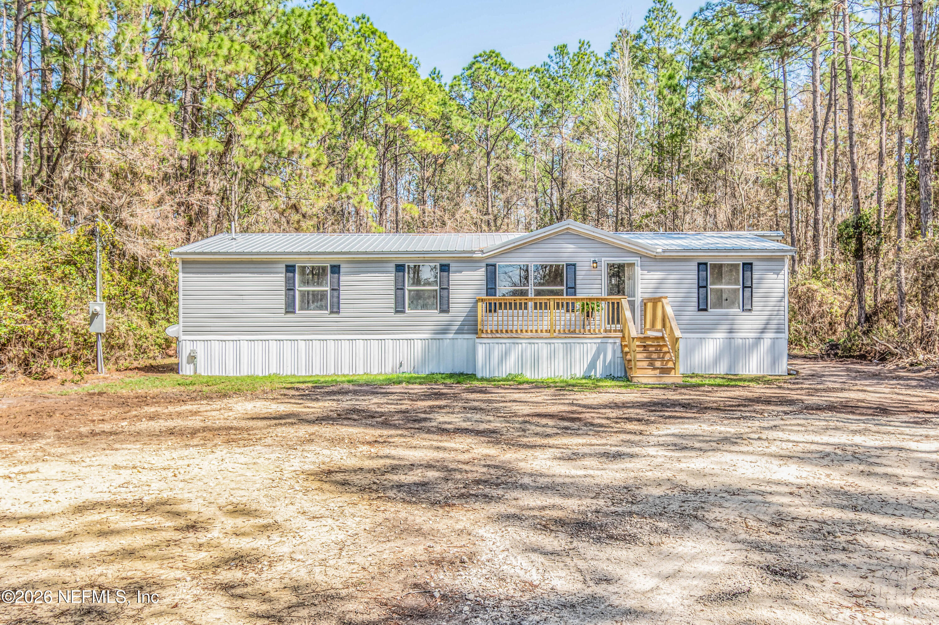 11017 County Road 229 Sanderson, FL 32087 - Photo 2 of 33 a front view of a house with a garden and trees