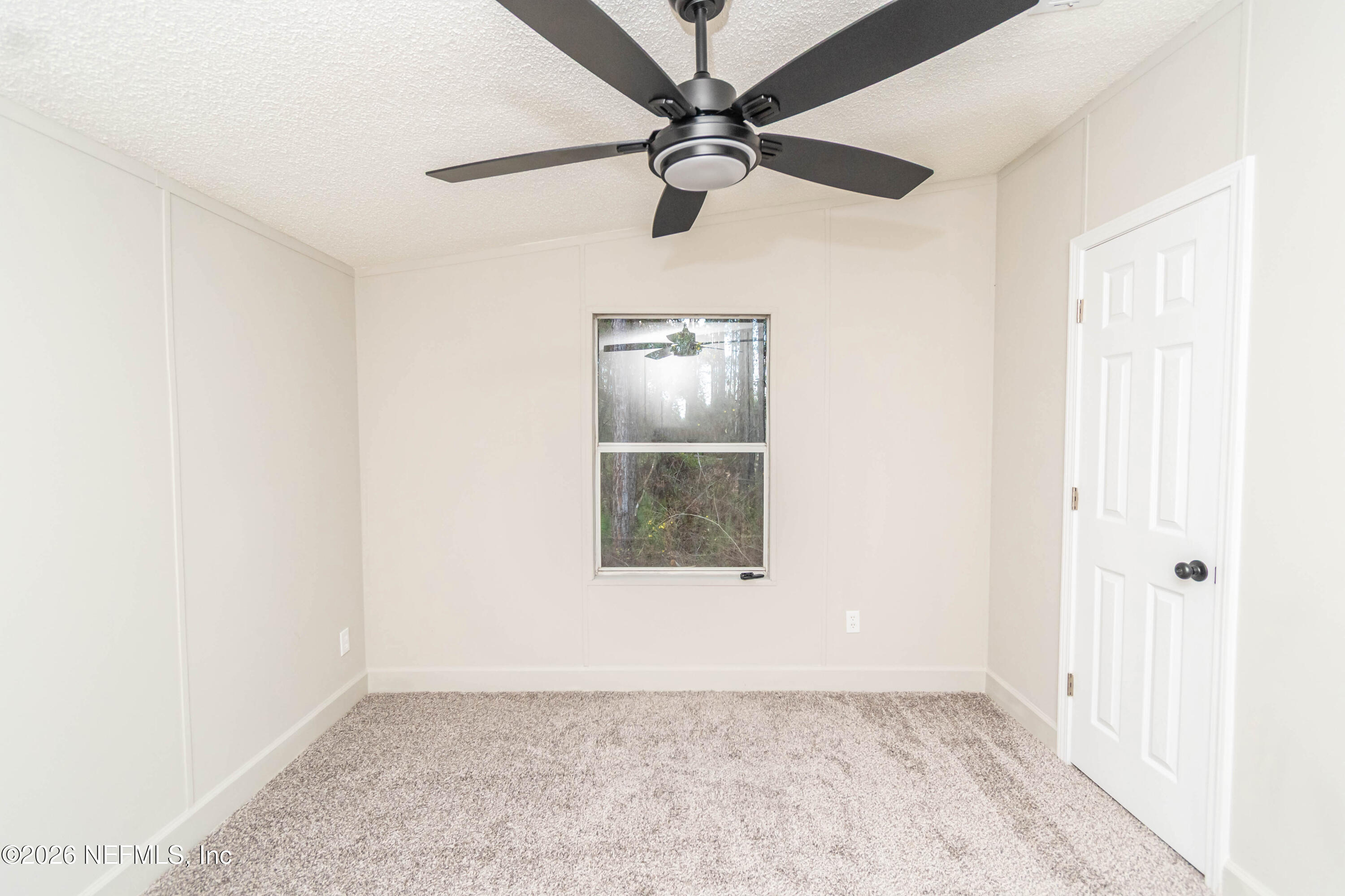 11017 County Road 229 Sanderson, FL 32087 - Photo 25 of 33 an empty room with a window and a fan