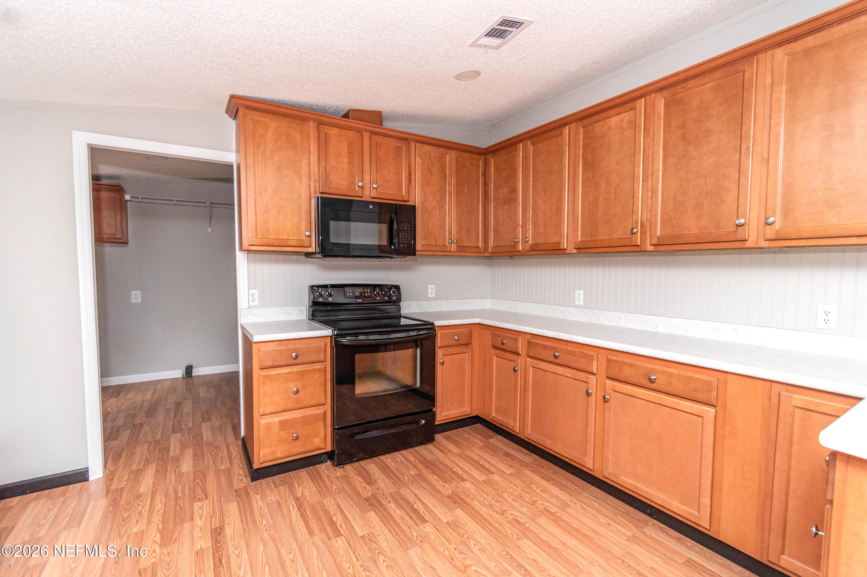 11017 County Road 229 Sanderson, FL 32087 - Photo 5 of 33 a kitchen with stainless steel appliances a stove a sink and a microwave